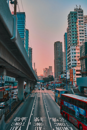 Cars On Road Between Buildings During Daytime Photo