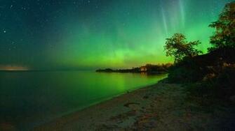 An Aurora Borealis Shines Over Laurentian Beach On The Eastern Shore