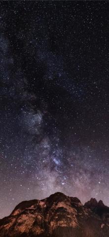 Brown And Black Mountain During Starry Night iPhone X Wallpaper