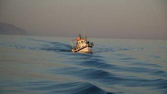 Small Fishing Boat At Sea Wallpaper