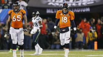 Denver Broncos Quarterback Peyton Manning Walks With Teammate