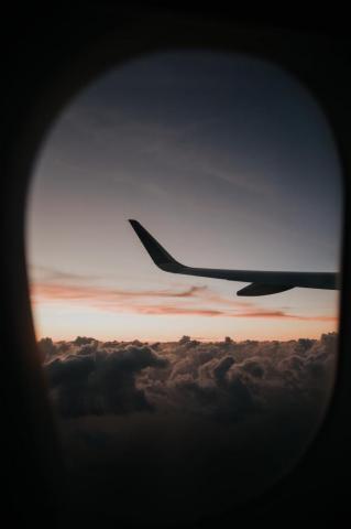 Passenger Plane Flying Over Clouds Photo Image