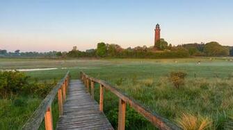 Boardwalk With At Neuland Lighthouse Behrensdorf Hohwacht