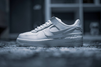 4k White Nike Shoe On Carpet Wallpaper
