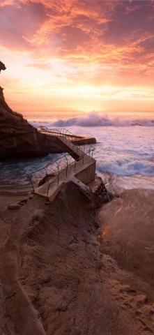 Waves Crashing On Rocky Coast During Sunset iPhone X Wallpaper