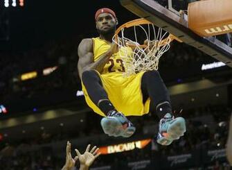 Cleveland Cavaliers Forward Lebron James Hangs Onto The Basket