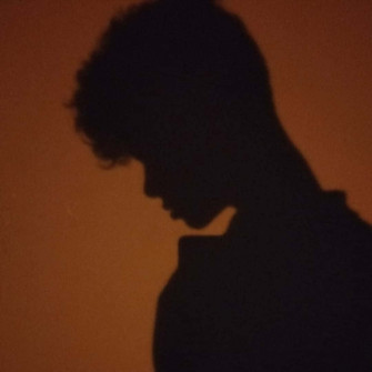 Enigmatic Curly Haired Figure In Shadow Pfp Wallpaper