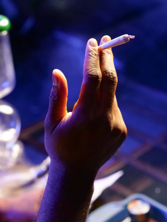 A Person Is Holding Cigarette In Their Hand Wallpaper