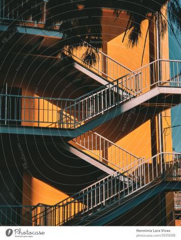 Colorful Staircase With Yellow Wall On Sunny Day Wallpaper Of A