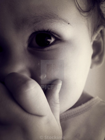 Baby Girl Crying With Hand Covering Her Mouth License