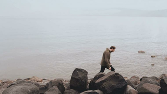 Caucasian Man At The Edge Of Sea Galilee Big Stones Shore