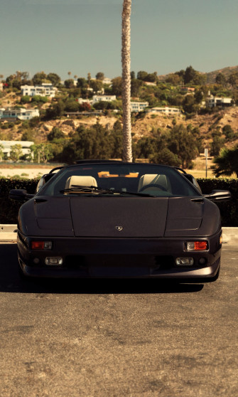A Black Car Parked On Road Photo Malibu Image