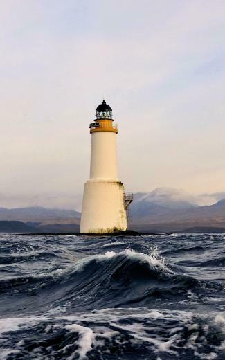 Lighthouse On A Small Piece Of Land Mobile Wallpaper