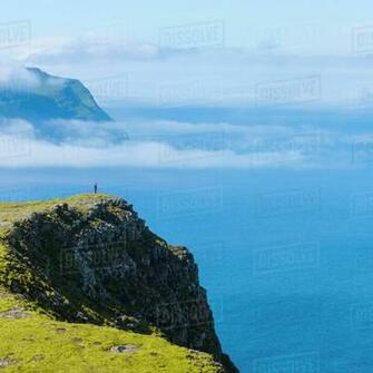 Seaside Cliffs Person On Background Stock Photo Dissolve