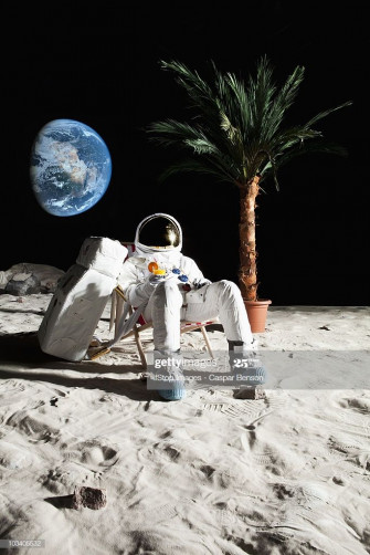 An Astronaut On The Moon Relaxing In A Beach Chair