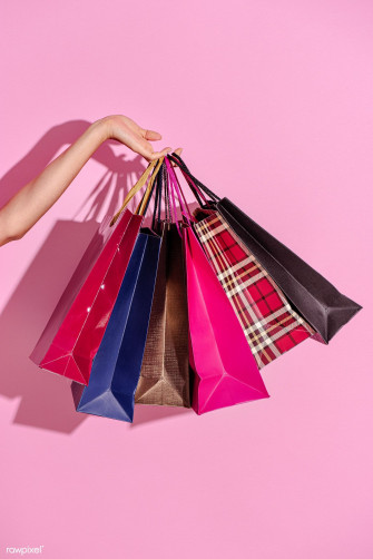 Woman Carrying Shopping Bags Against A Pink Background Wallpaper