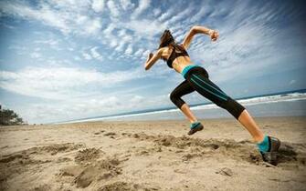 Girl Wearing Sportswear Ready To Start Running On Beach Jpg