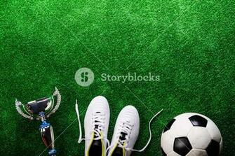 Soccer Ball Cleats And Trophy Against Artificial Turf Studio