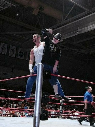 Jimmy Wang Yang Standing On The Ropes With His Child Fan