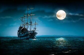 One Beautiful Pirate Ship Sailing In Blue Ocean By The Bright Full