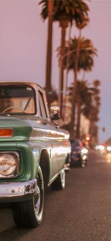 Vintage Car Parked On Ocean Blvd During Sunset iPhone X Wallpaper
