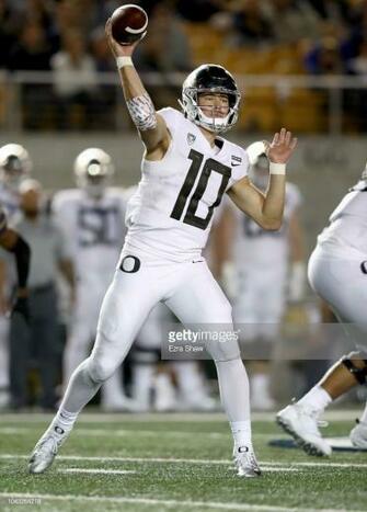 Justin Herbert Of The Oregon Ducks Passes Ball Against