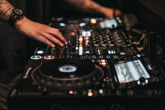 Person Playing Dj Controller In A Room Photo Image On