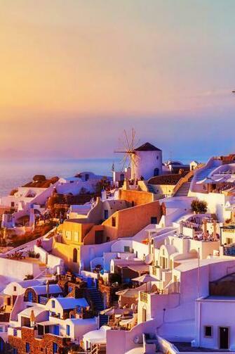 The Spectacular Sunset Over Oia Village In Santorini Greece