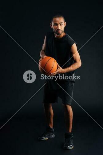 Full Length Portrait Of A Serious African Sportsman Playing