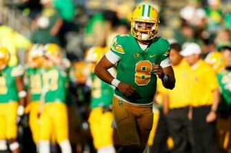 Oregon Quarterback Marcus Mariota Warms Up Before The Start Of An