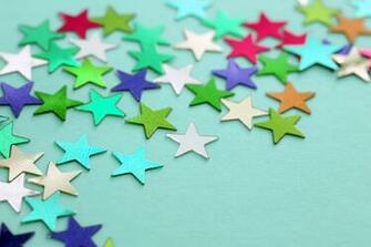 Image Of Colorful Stars Scattered On Light Blue Background