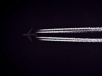 Photo Of Airplane Across The Clouds During Night Time