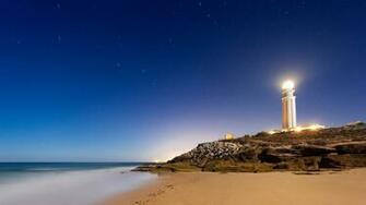 Wallpaper Lighthouse Sand Footprints Stones 4k