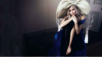Abbey Lee Kershaw Sitting In Blue Dress Wallpaper
