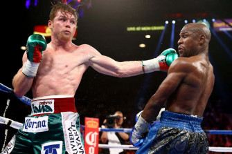 A Boxer Is Throwing Punch To Another Wallpaper